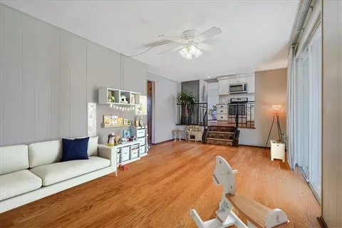 a living room with furniture and kitchen view
