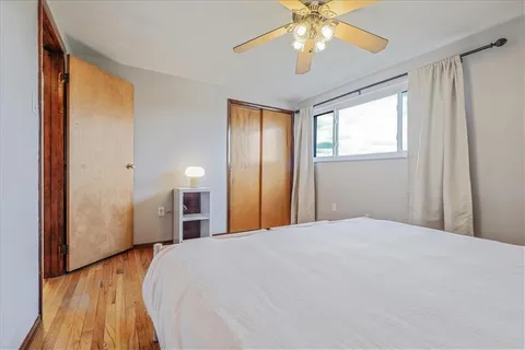 a bedroom with a large bed and a chandelier