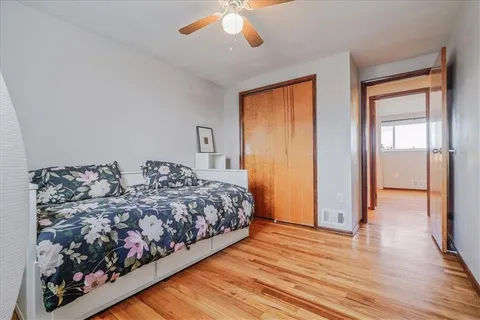 a bedroom with a large bed and a chandelier