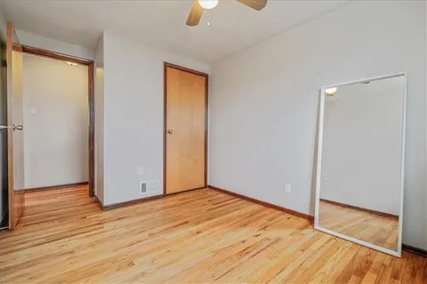 an empty room with wooden floor and door