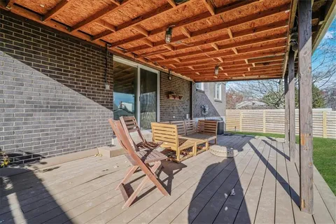 a view of balcony with wooden floor and outdoor seating