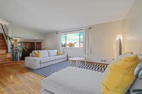 a bedroom with furniture and wooden floor
