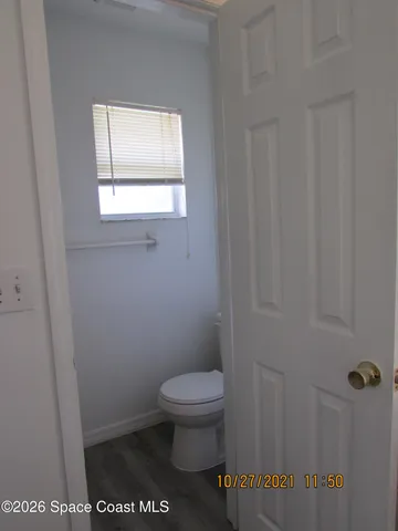 a bathroom with a toilet and a window