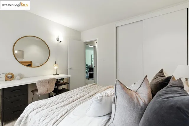 a bedroom with a bed and a mirror