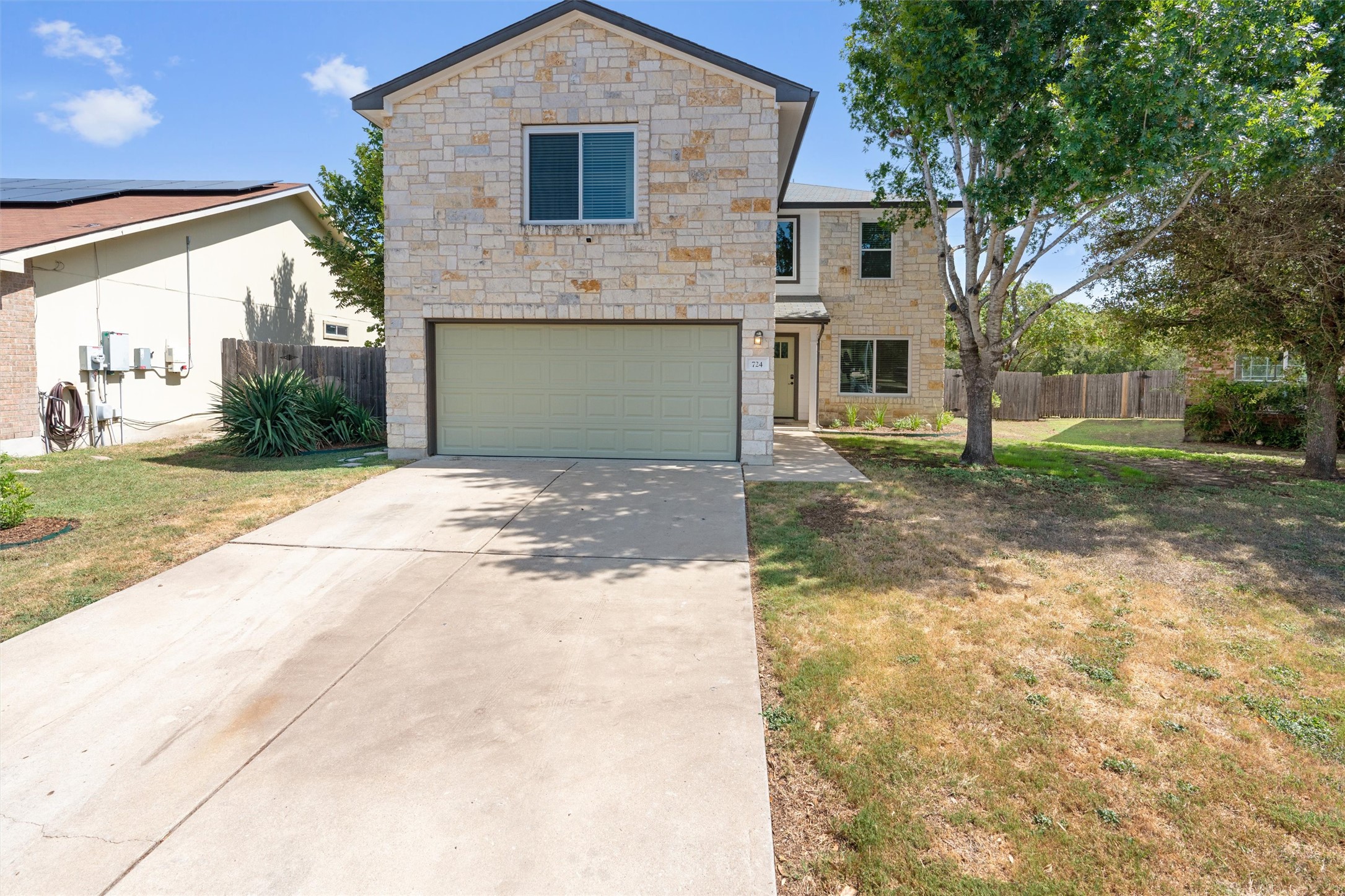 724 Lavaca Loop Elgin, TX 78621 - Photo 7 of 40 Textured light stone masonry defines this multi-level home's exterior facade and integrated garage.