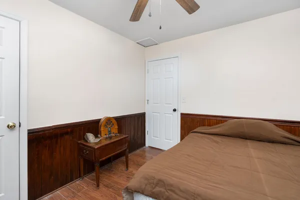 a kitchen with stainless steel appliances wooden floor dining table and chairs