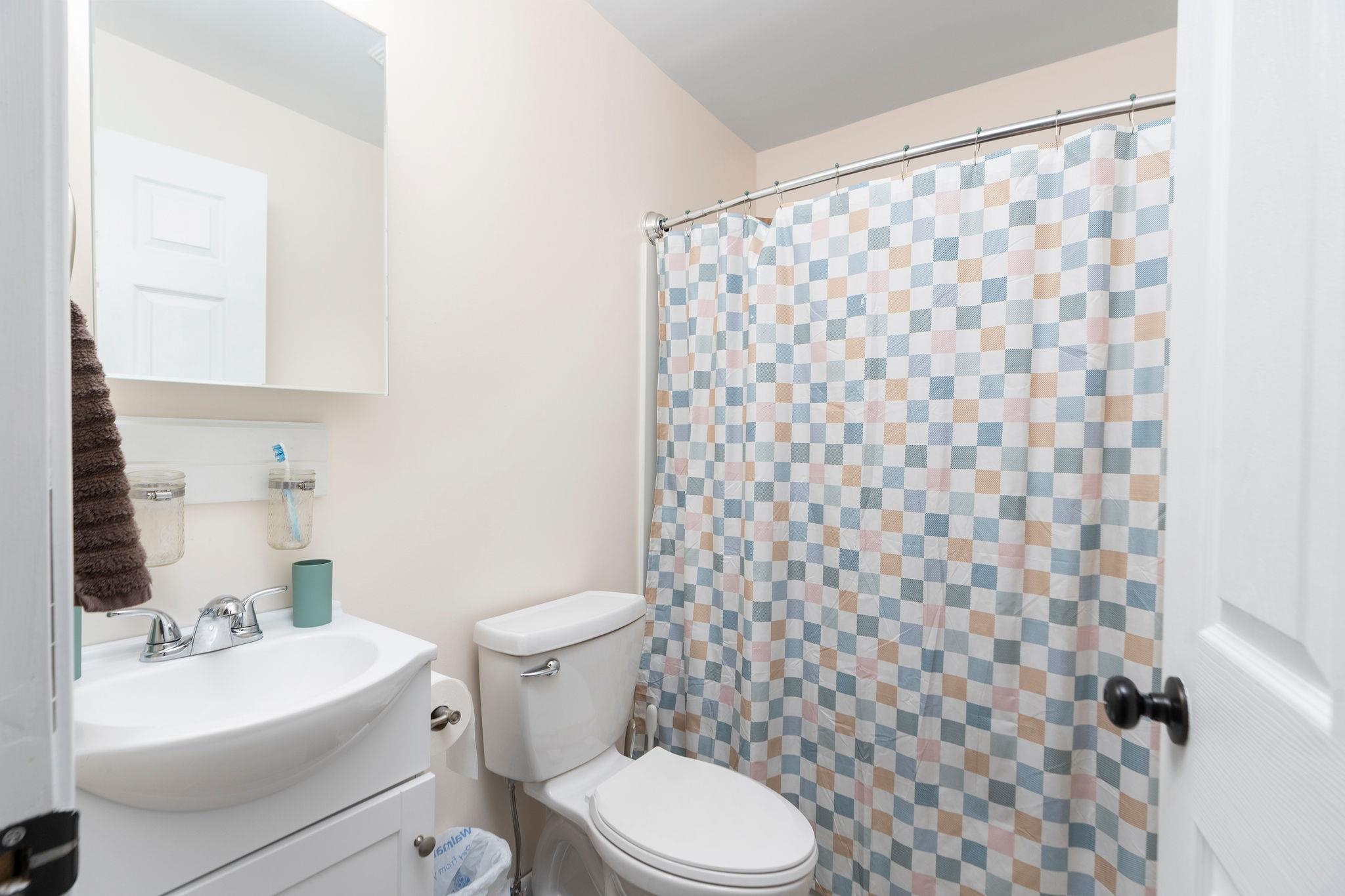 887 Bright Hollow Road Deerfield, VA 24432 - Photo 19 of 73 a white toilet sitting next to a white sink and a shower curtain