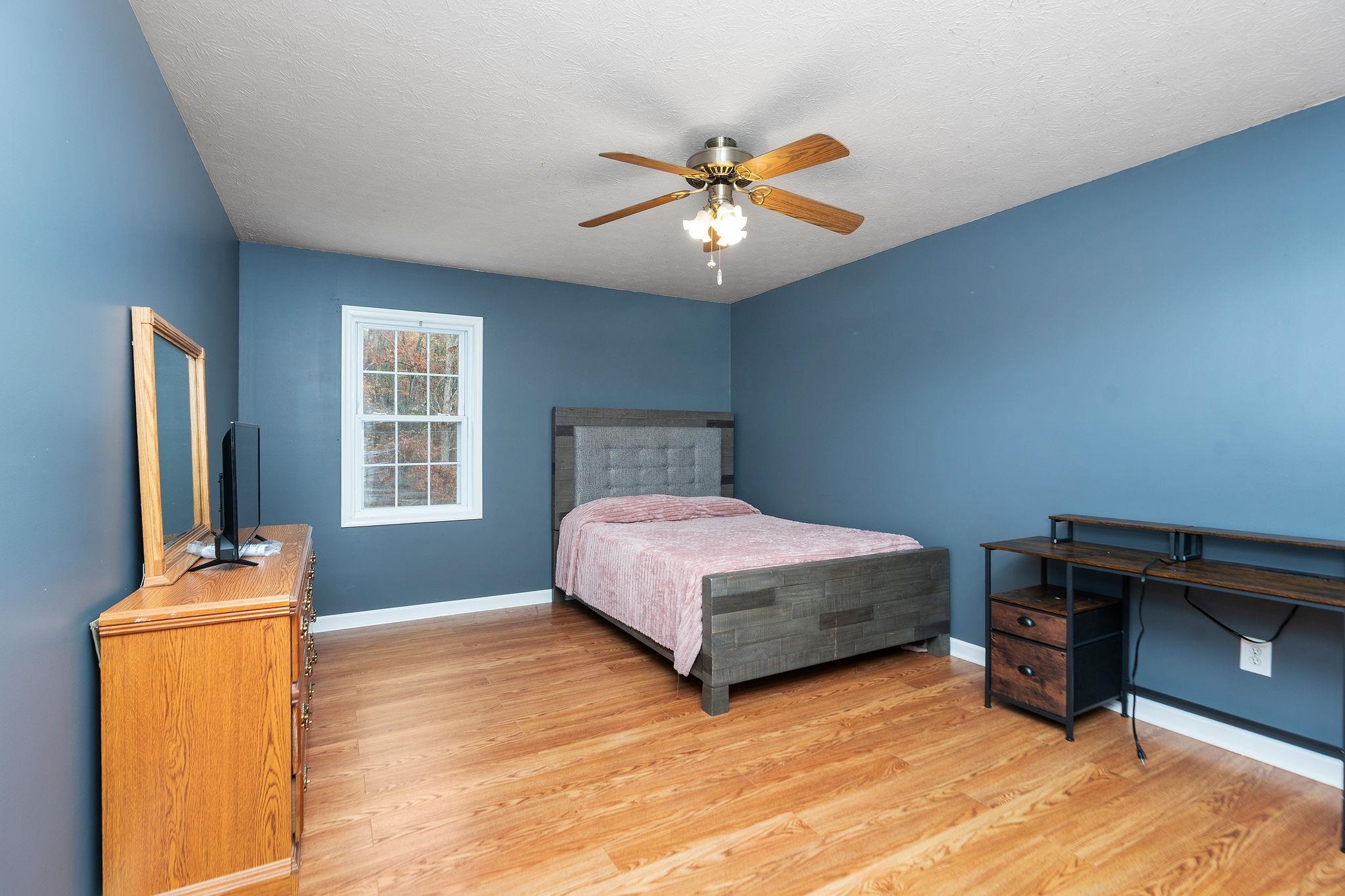 887 Bright Hollow Road Deerfield, VA 24432 - Photo 22 of 73 a bedroom with a bed and a chandelier