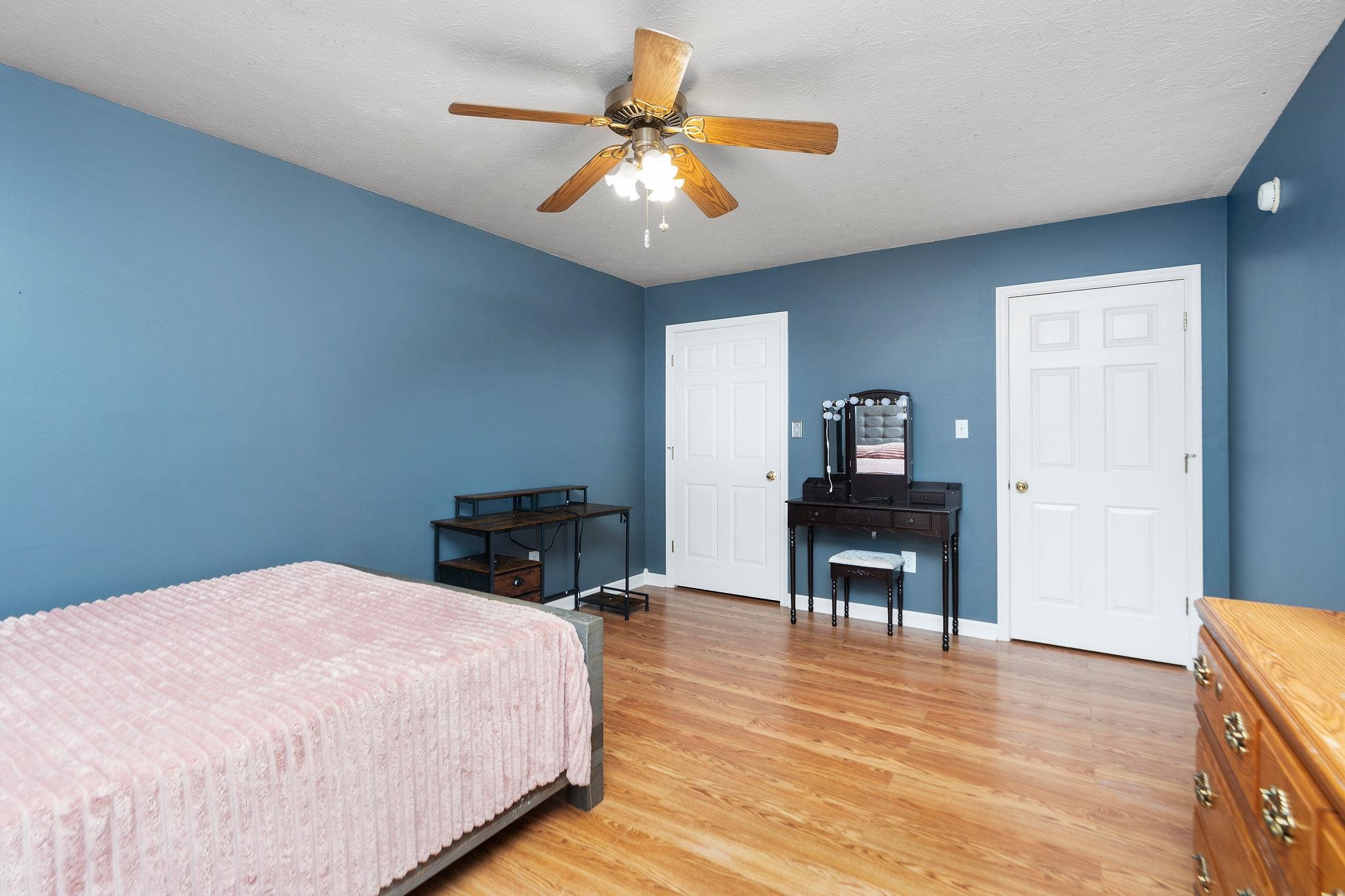 887 Bright Hollow Road Deerfield, VA 24432 - Photo 23 of 73 a bedroom with a bed and a chandelier