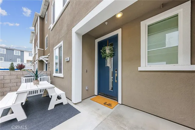 a living room with furniture a rug and white walls