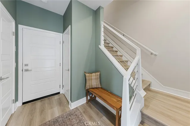 a view of entryway and hall with wooden floor