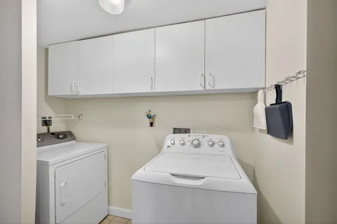 a bathroom with a sink a toilet a large mirror and shower