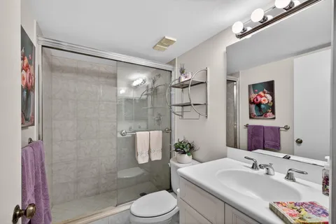 a bathroom with a toilet a sink and shower