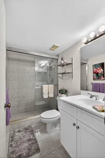 a spacious bathroom with a granite countertop sink a mirror and a
