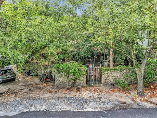 a wooden house with trees in front of it