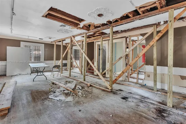a view of a livingroom with wooden floor and windows