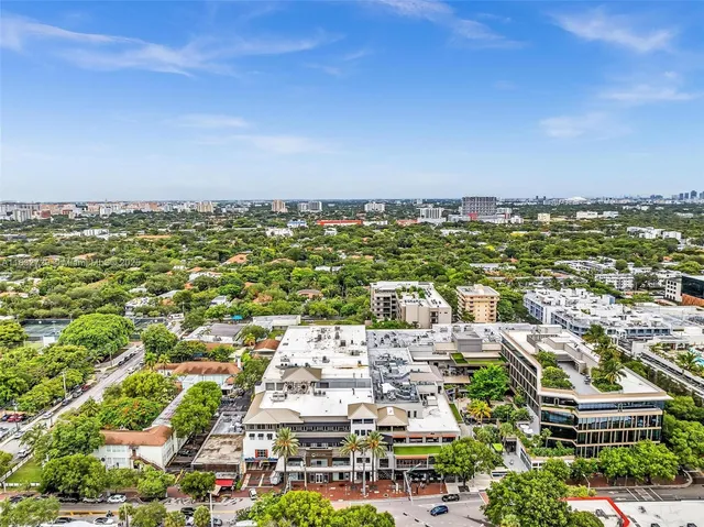 an aerial view of multiple houses with yard