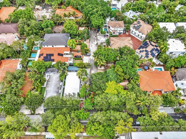 a view of a street with a small garden