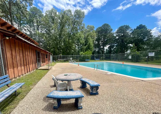 a view of a backyard with swimming pool