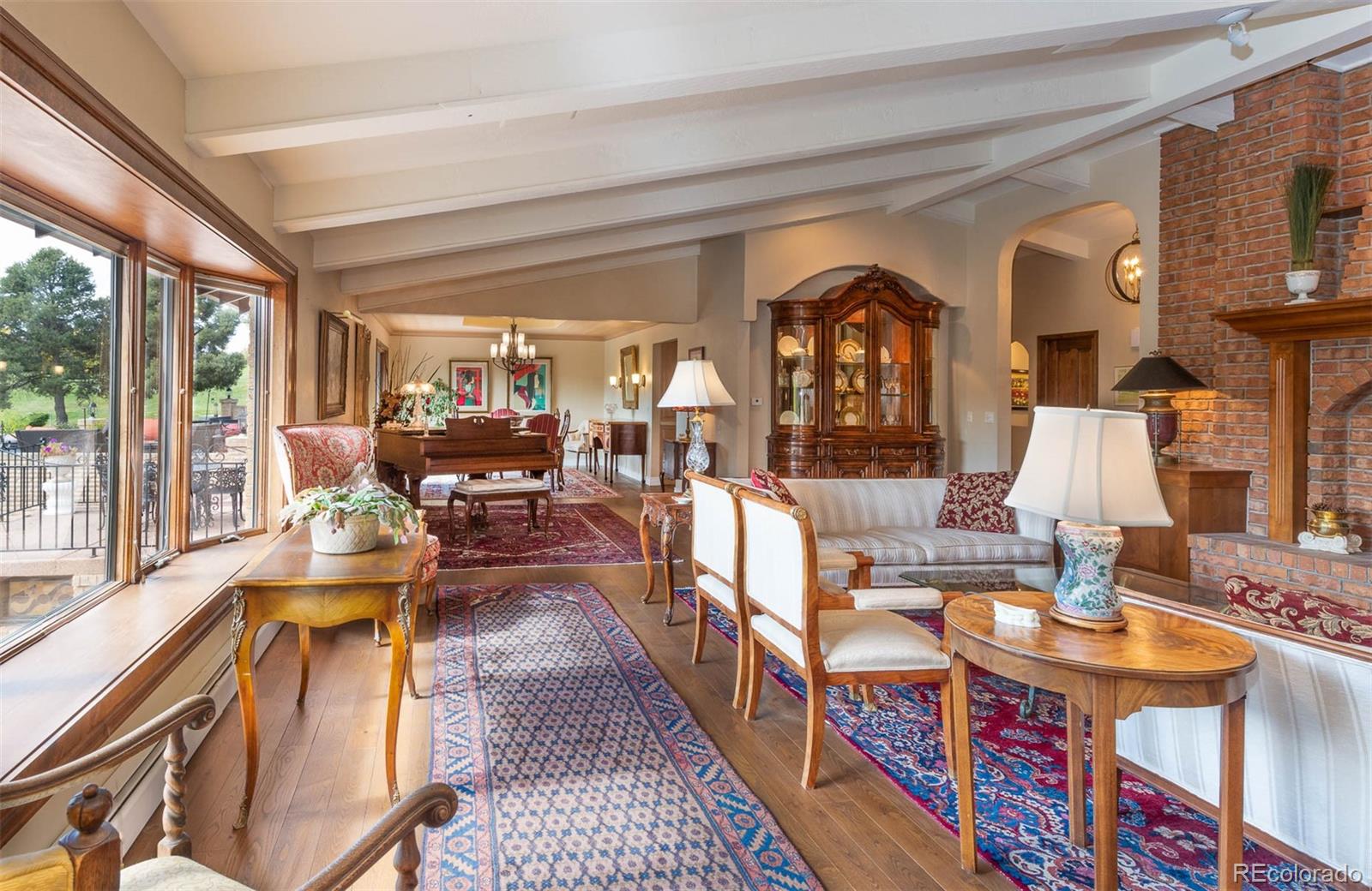3942 South Pinehurst Circle Denver, CO 80235 - Photo 12 of 25 a living room with fireplace furniture and a large window