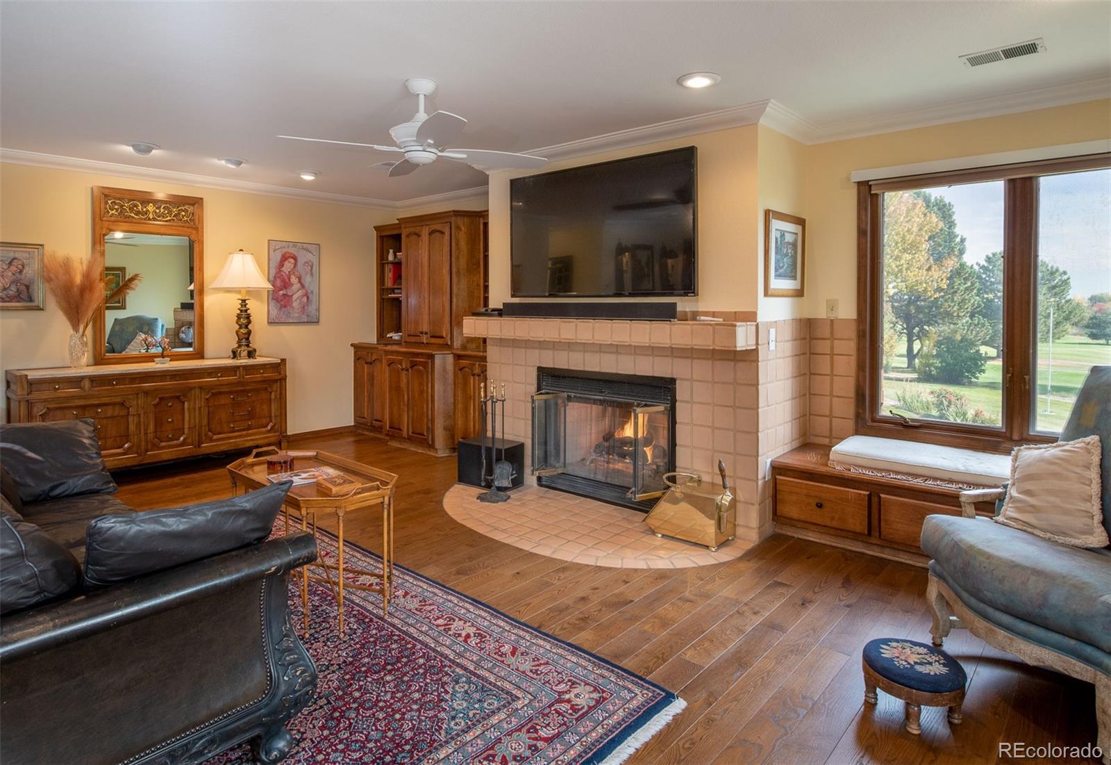 3942 South Pinehurst Circle Denver, CO 80235 - Photo 16 of 25 a living room with furniture fireplace and flat screen tv