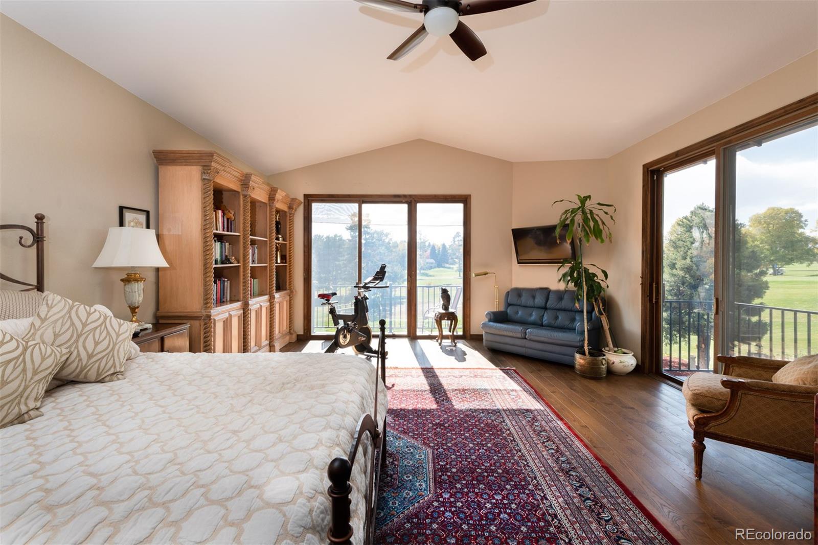 3942 South Pinehurst Circle Denver, CO 80235 - Photo 19 of 25 a bedroom with a large bed and a large window
