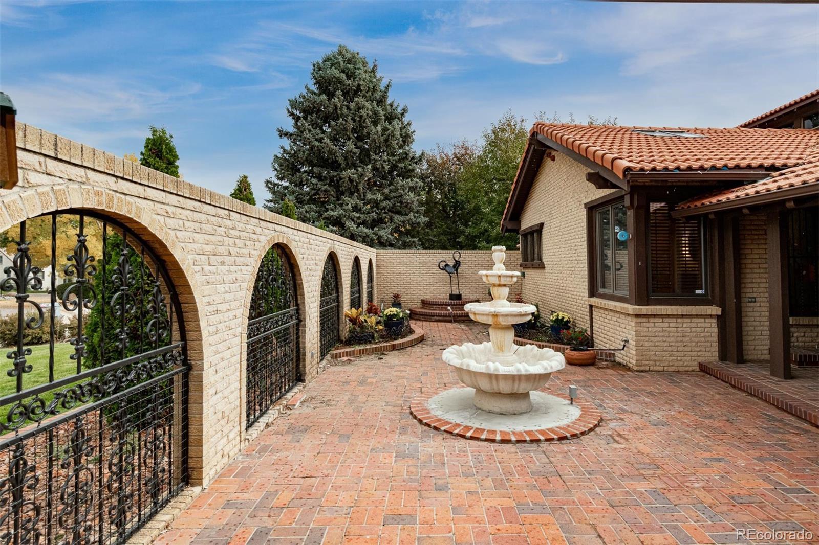 3942 South Pinehurst Circle Denver, CO 80235 - Photo 2 of 25 a view of a house with backyard and sitting area