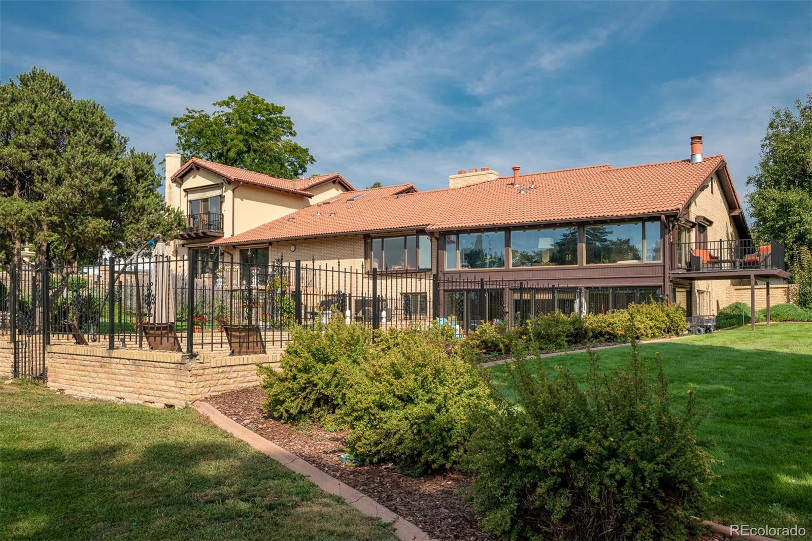 3942 South Pinehurst Circle Denver, CO 80235 - Photo 23 of 25 a front view of a house with a yard