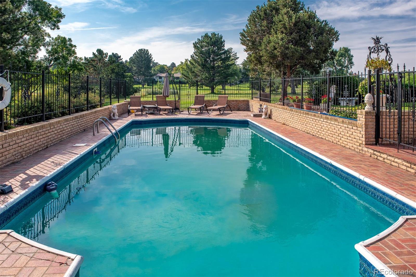 3942 South Pinehurst Circle Denver, CO 80235 - Photo 24 of 25 a view of a house with a yard