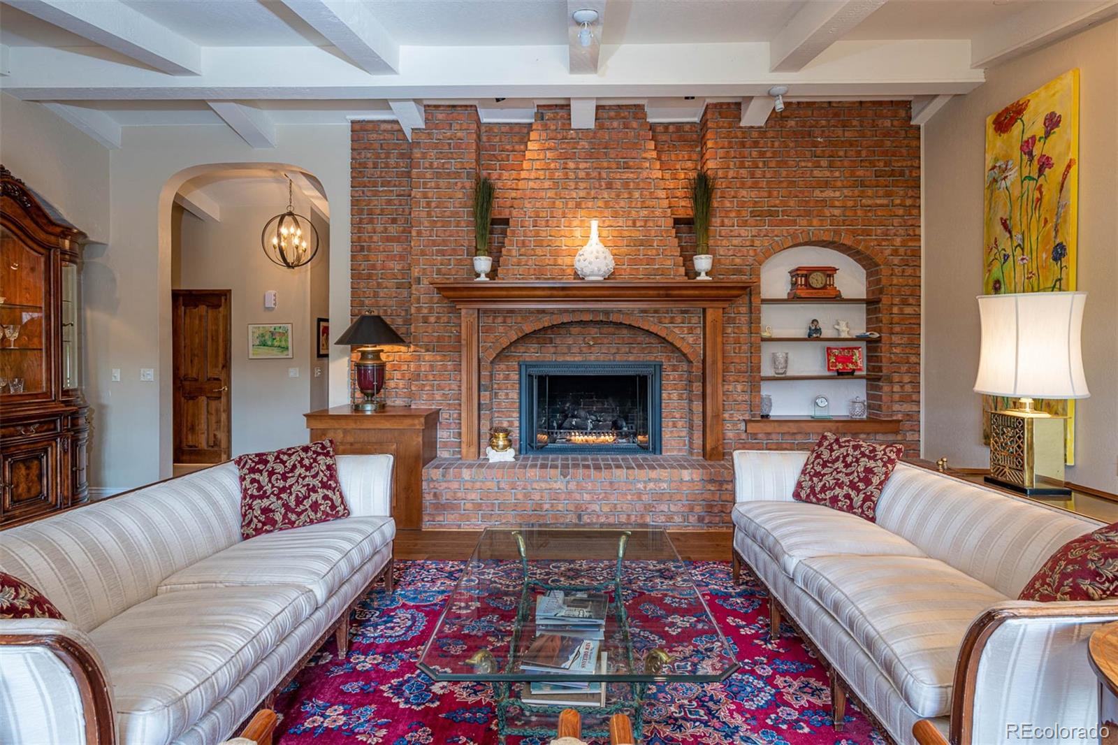 3942 South Pinehurst Circle Denver, CO 80235 - Photo 5 of 25 a living room with furniture and a fireplace
