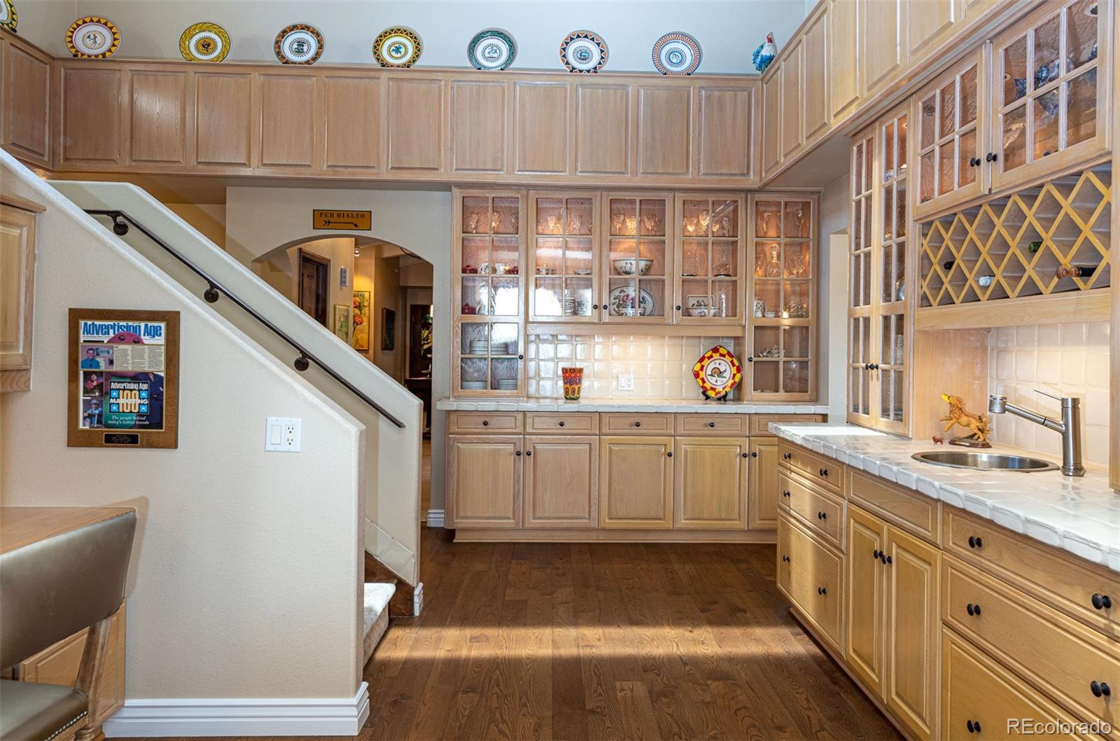 3942 South Pinehurst Circle Denver, CO 80235 - Photo 10 of 25 a kitchen with a refrigerator and a sink