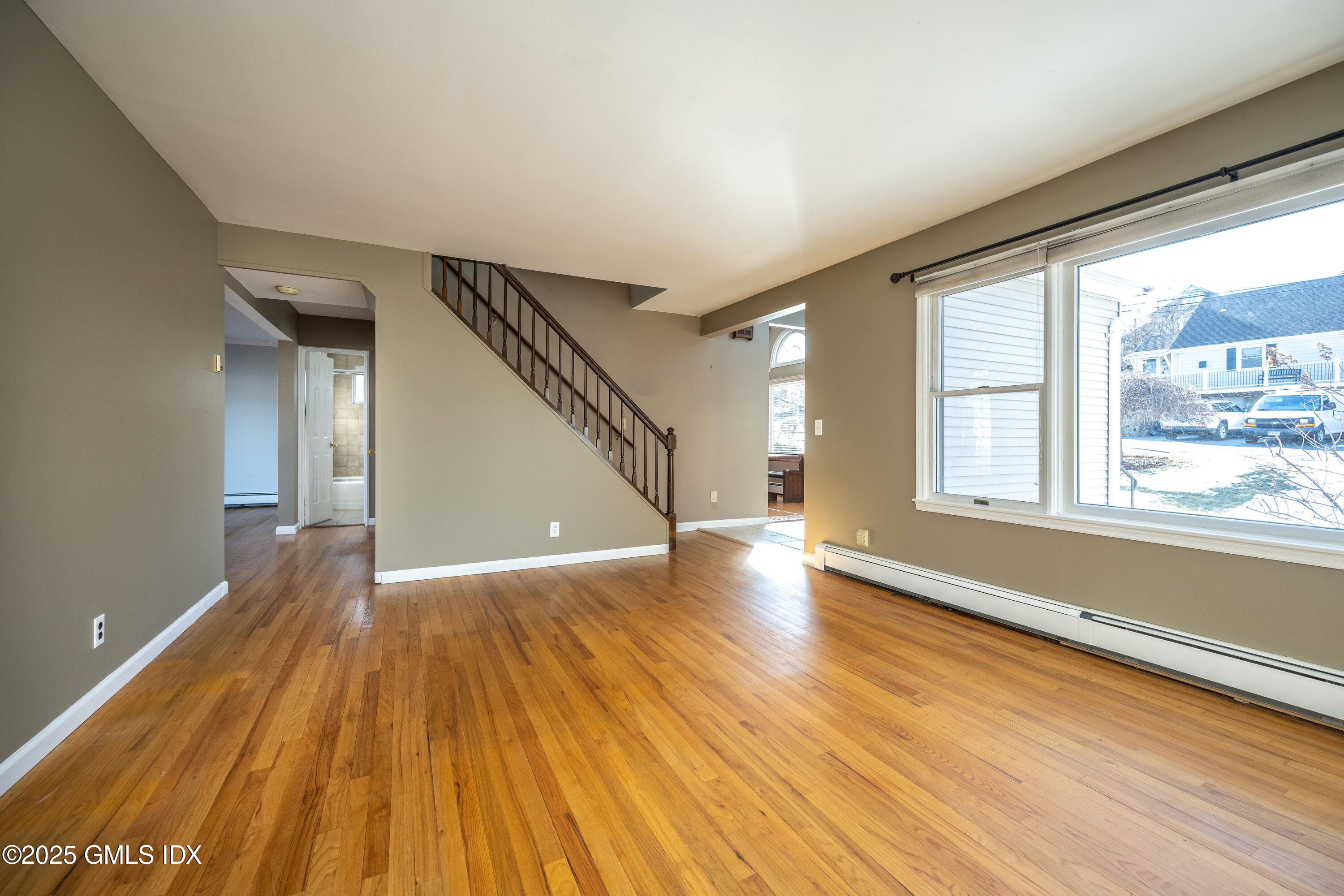 46 Cambridge Road Stamford, CT 06902 - Photo 12 of 29 a view of an empty room with wooden floor and a window