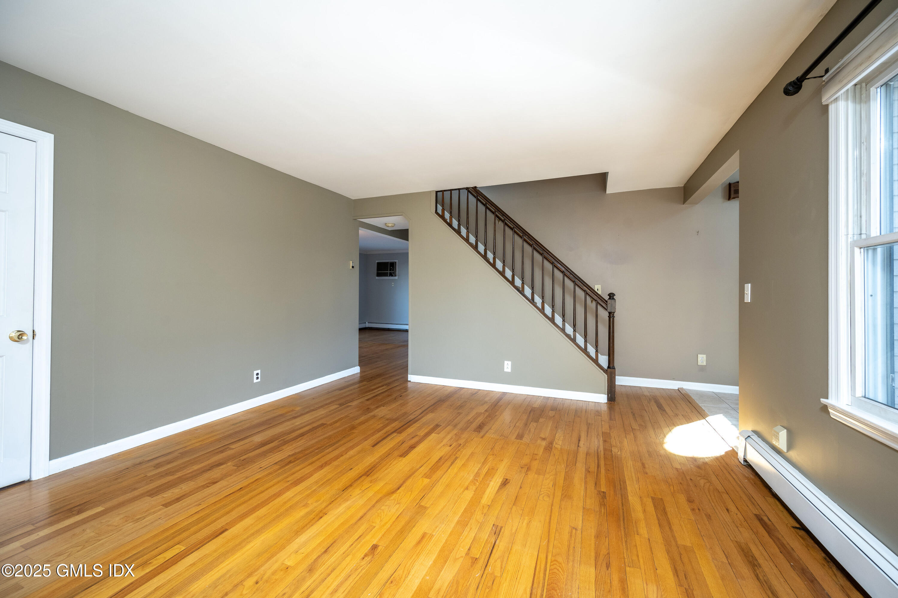 46 Cambridge Road Stamford, CT 06902 - Photo 13 of 29 a view of an empty room with wooden floor and a window