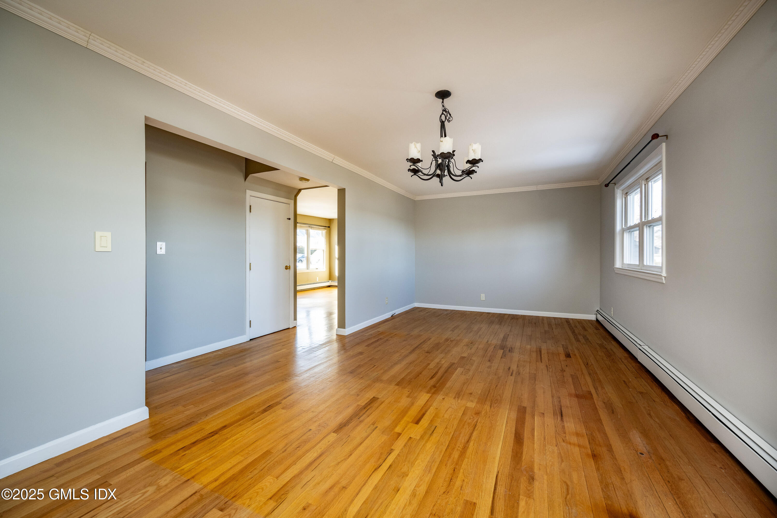 46 Cambridge Road Stamford, CT 06902 - Photo 14 of 29 a view of an empty room with wooden floor and a window