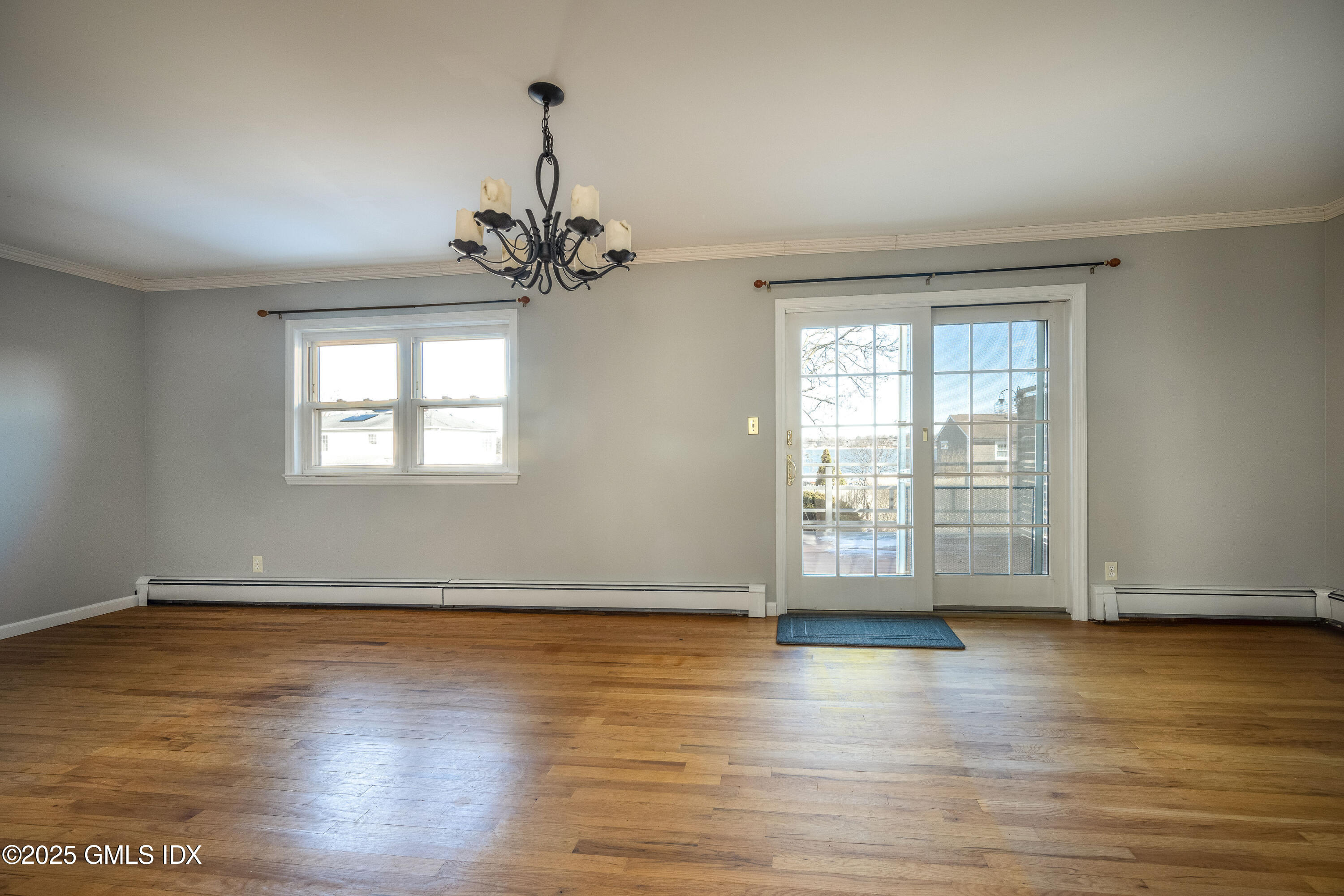 46 Cambridge Road Stamford, CT 06902 - Photo 15 of 29 a view of an empty room with wooden floor and a window