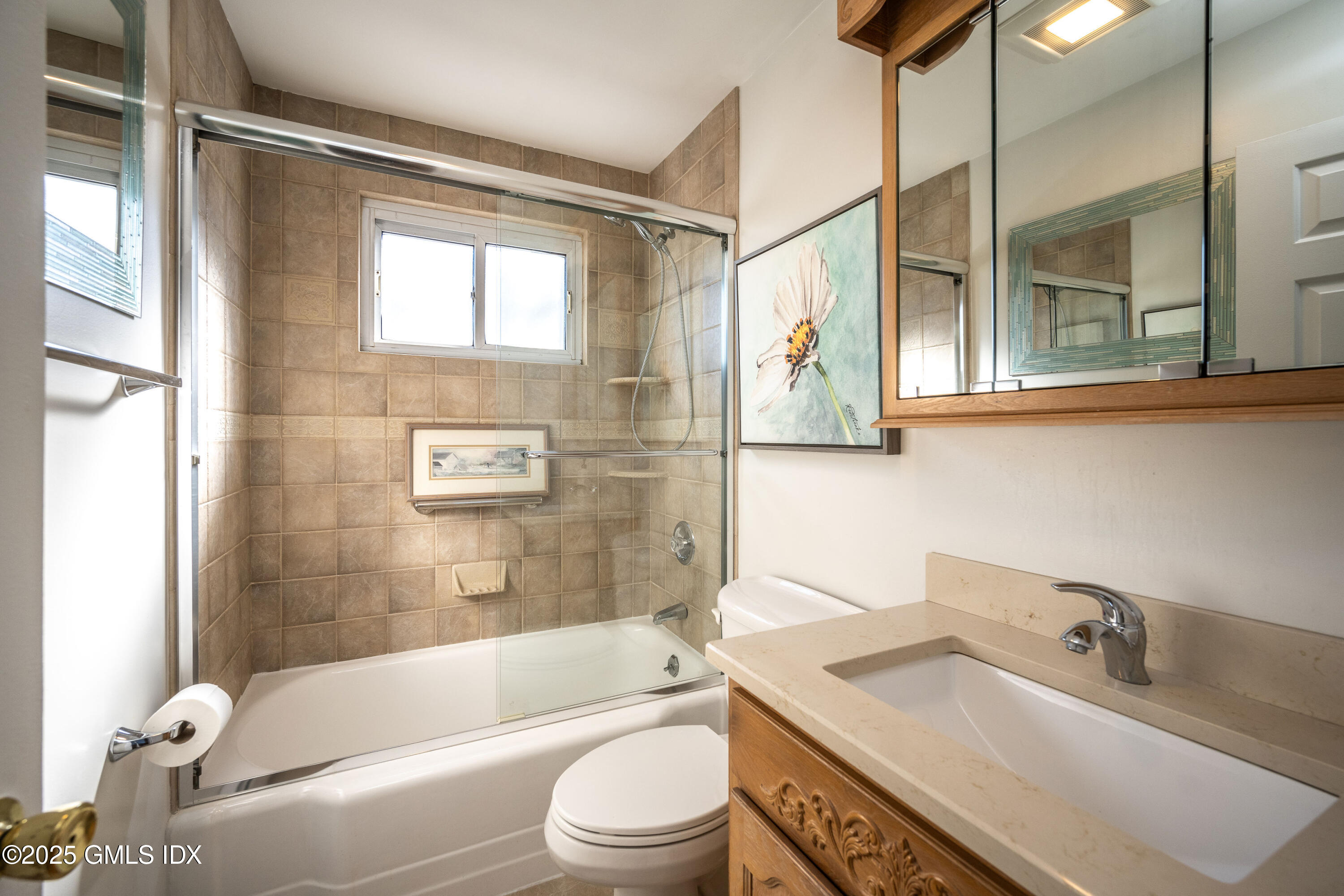 46 Cambridge Road Stamford, CT 06902 - Photo 17 of 29 a bathroom with a granite countertop sink toilet mirror and bathtub
