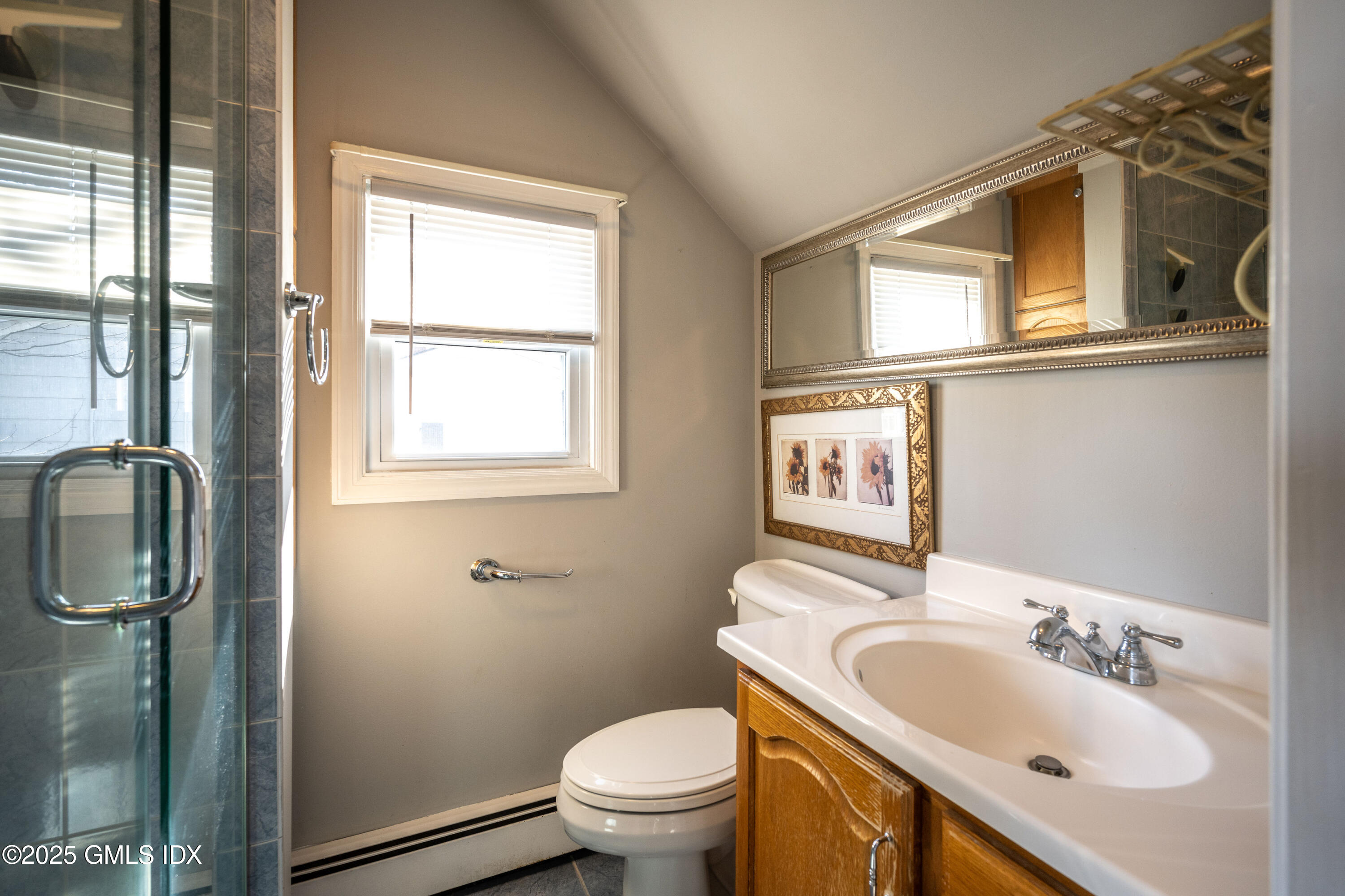 46 Cambridge Road Stamford, CT 06902 - Photo 20 of 29 a bathroom with a granite countertop toilet a sink and a mirror