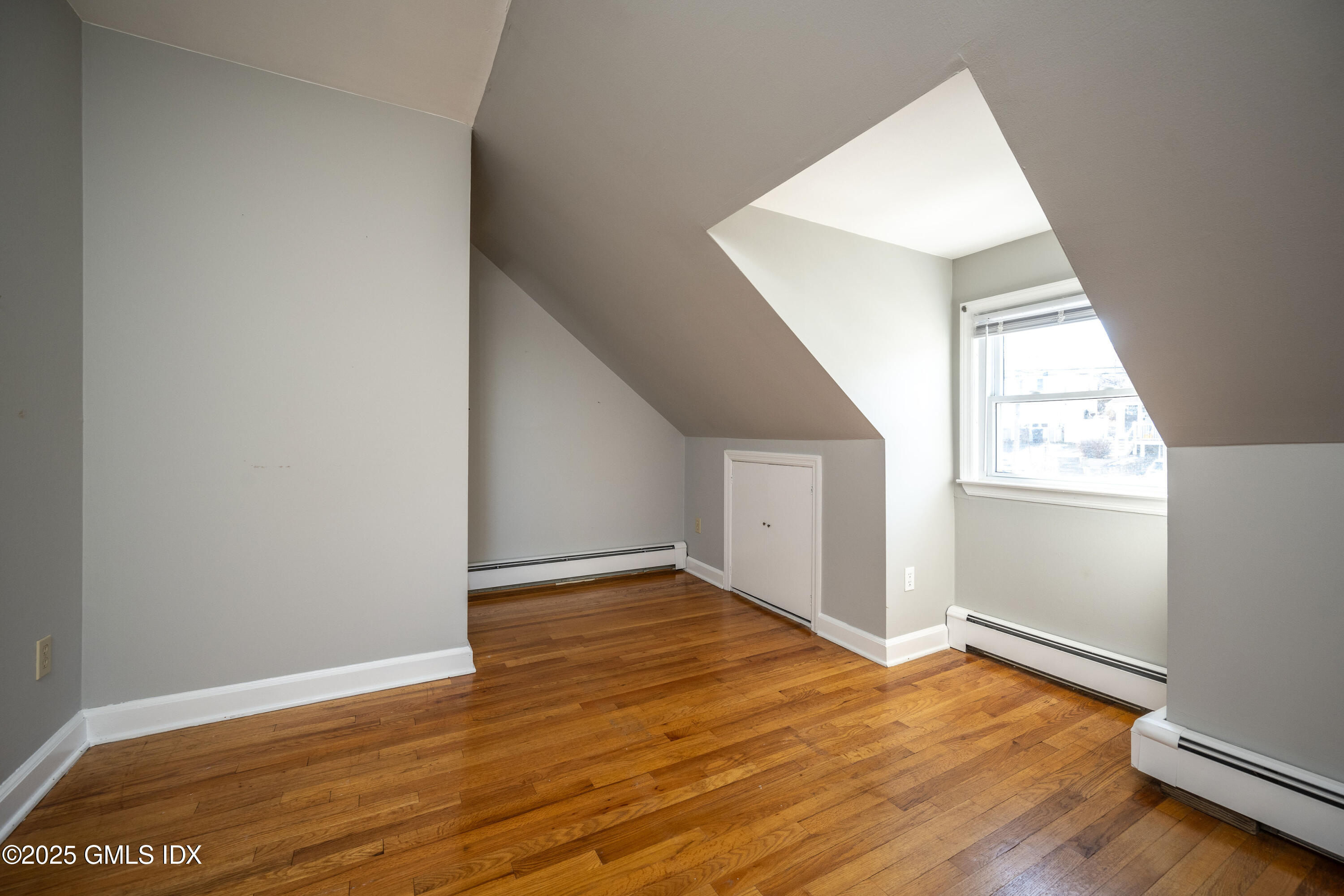 46 Cambridge Road Stamford, CT 06902 - Photo 23 of 29 an empty room with wooden floor and windows