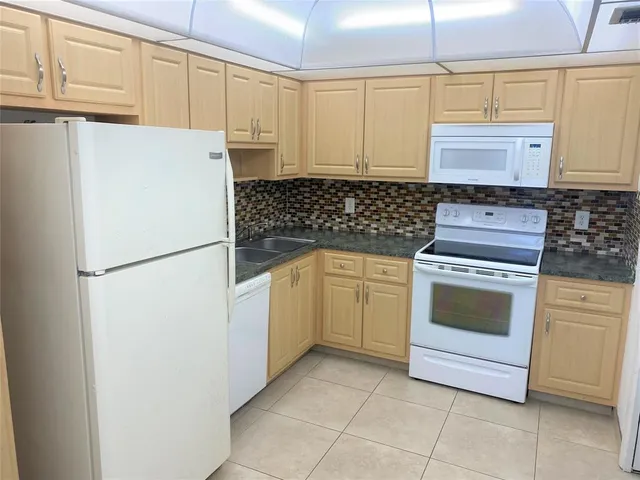 a kitchen with a stove a sink and a refrigerator