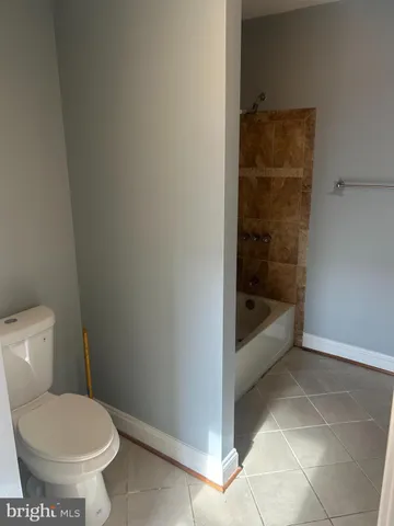 a bathroom with a toilet and bathtub