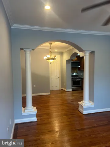 a view of empty room with wooden floor
