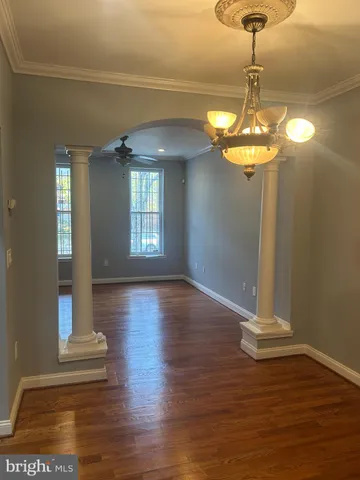 a view of a room with wooden floor chandelier and entryway