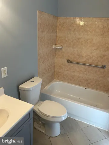 a bathroom with a toilet and a bath tub