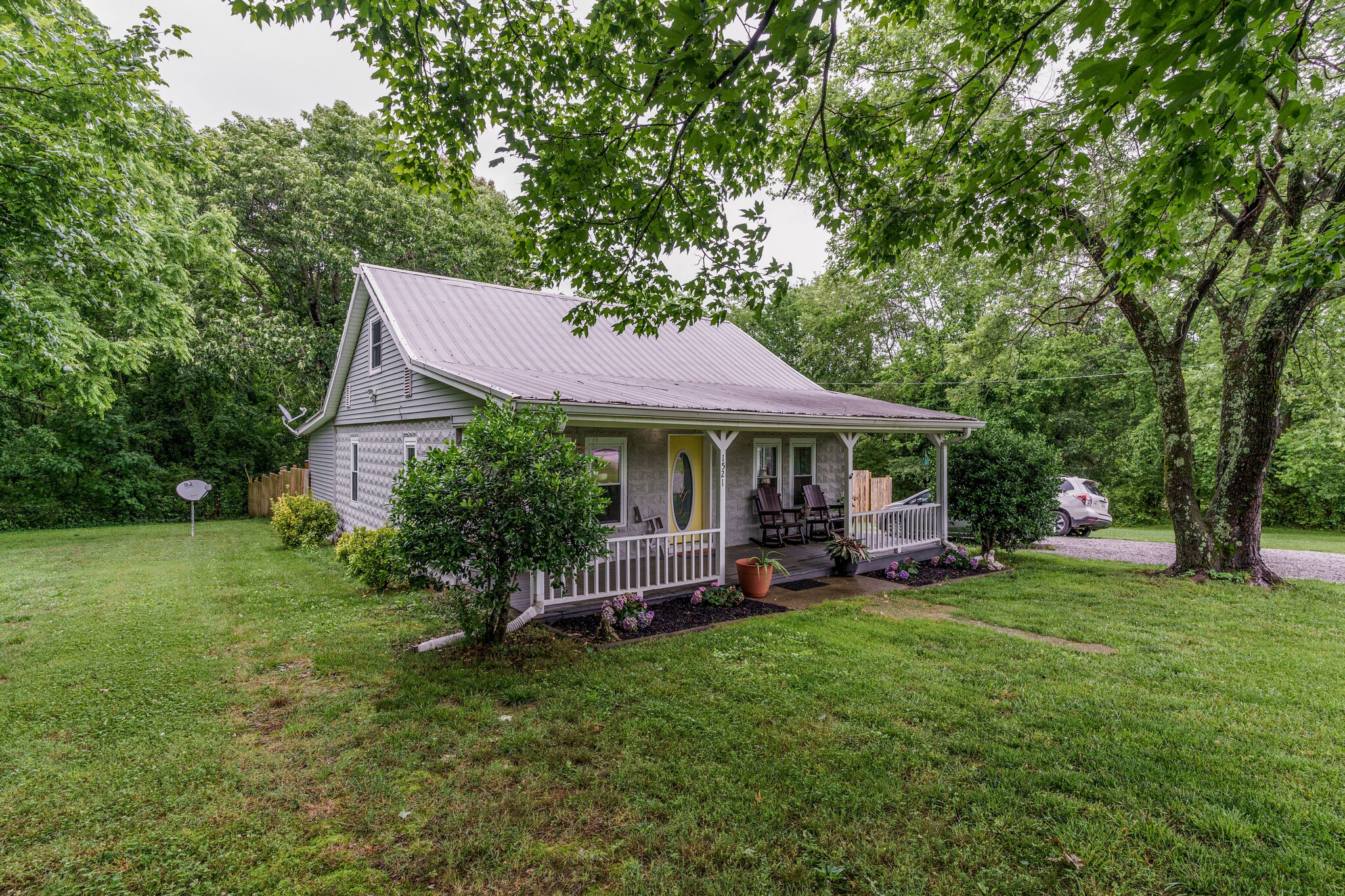 1521 Hogan Road Burns, TN 37029 - Photo 1 of 33 a front view of a house with garden
