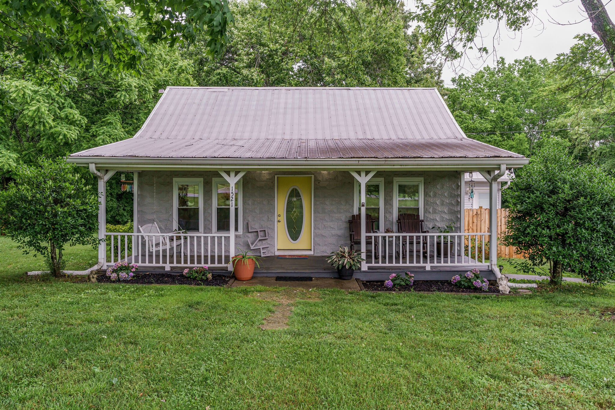 1521 Hogan Road Burns, TN 37029 - Photo 2 of 33 a front view of a house with a garden