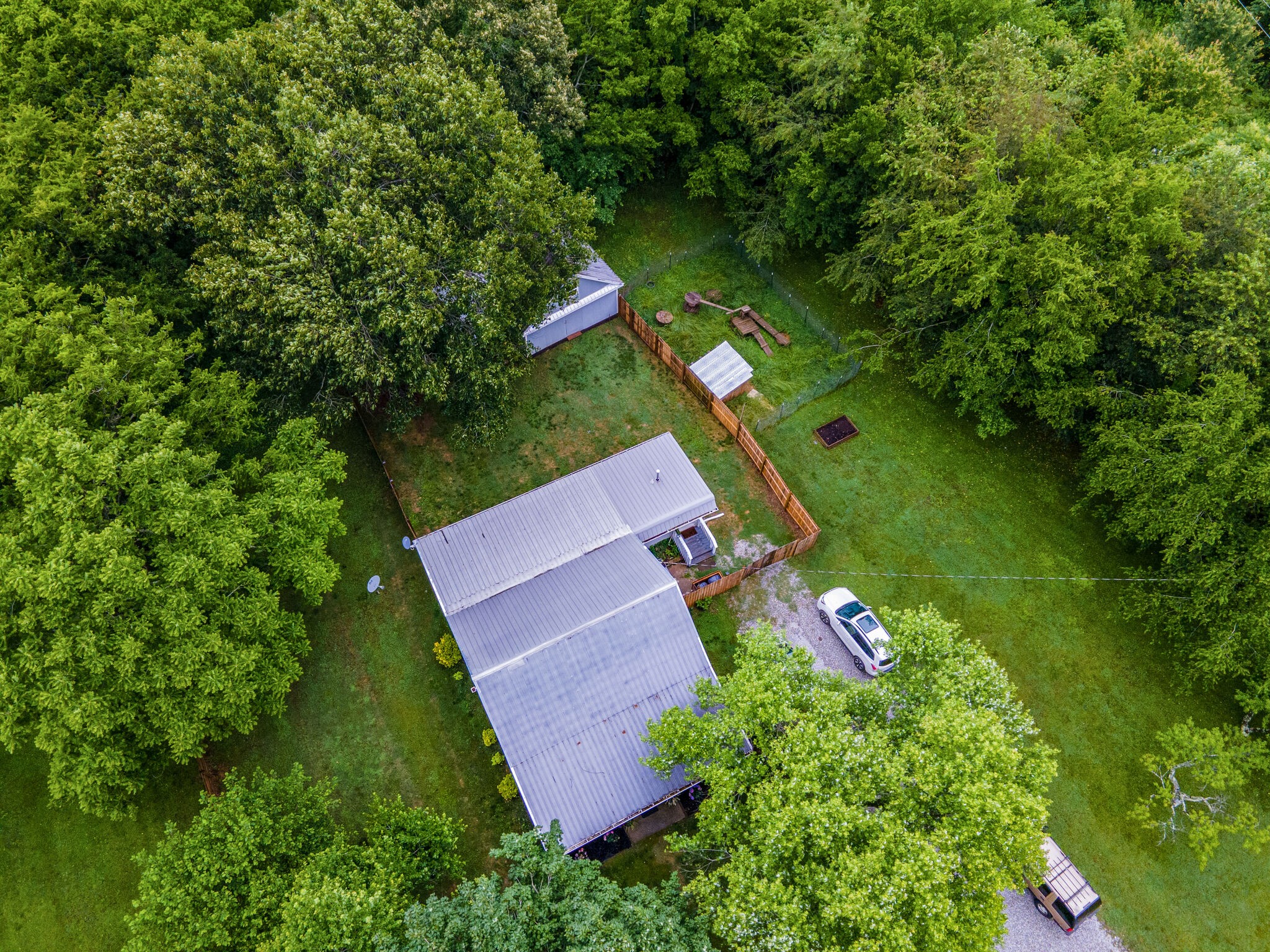 1521 Hogan Road Burns, TN 37029 - Photo 5 of 33 an aerial view of a house with outdoor space and trees all around