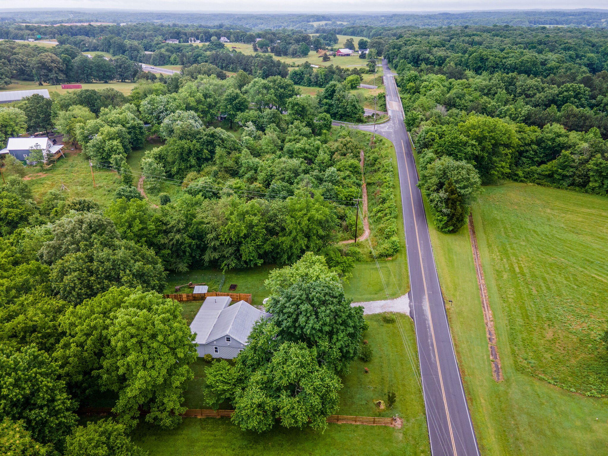 1521 Hogan Road Burns, TN 37029 - Photo 6 of 33 an aerial view of residential houses with outdoor space and trees
