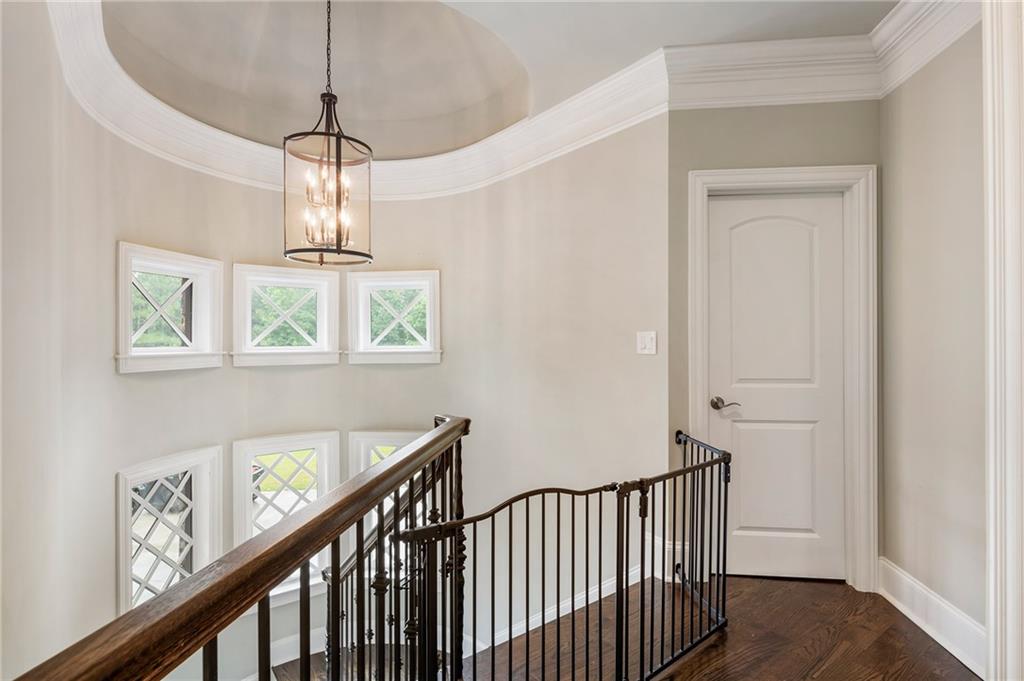14560 Wood Road Milton, GA 30004 - Photo 47 of 74 a view of a hallway with windows and chandelier