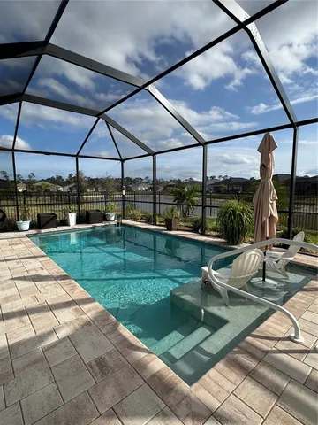 a view of a swimming pool with a patio