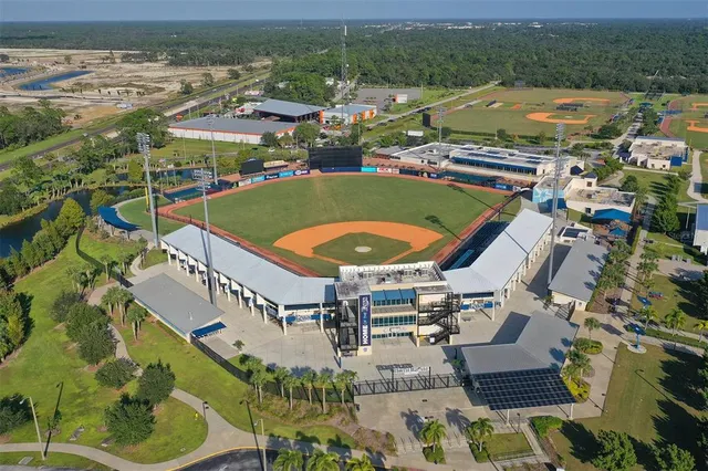 an aerial view of residential houses with outdoor space and river